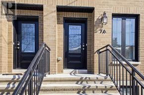 Ottawa apartment for rent - A house with a black front door and a black railing.