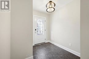 Ottawa apartment for rent - A white door with a window in the middle of a room with a light on the ceiling.