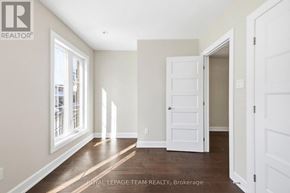 Ottawa apartment for rent - A white door is open in a room with wooden floors and white walls.
