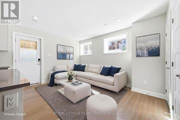 Ottawa apartment for rent - A living room with a white couch and a coffee table.
