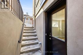 Ottawa apartment for rent - A set of stairs leading to a door with a glass window.
