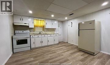 Windsor apartment for rent - A kitchen with white cabinets and a wooden floor.
