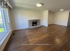 Toronto (Willowdale West) apartment for rent - A room with a fireplace and wooden floors.
