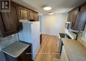 Toronto (Willowdale West) apartment for rent - A kitchen with brown cabinets and a white refrigerator.