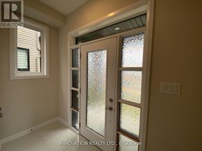 Ottawa townhouse for rent - A glass door with a handle is in the middle of a room.