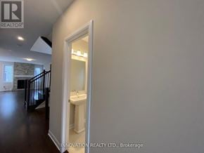 Ottawa townhouse for rent - A bathroom with a sink and mirror is shown in a real estate listing.