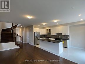 Ottawa townhouse for rent - A spacious, well-lit room with a bar area and a staircase.