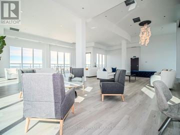 St. Catharines (Downtown) condo for rent - A living room with a grey sofa and chairs.