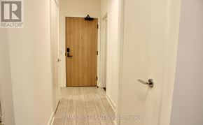 Toronto (Waterfront Communities) condo for rent - A hallway with a wooden door and a white door.