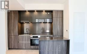 Toronto (Waterfront Communities) condo for rent - A modern kitchen with a stainless steel sink and countertop.