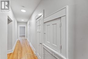 Ottawa apartment for rent - A long hallway with white walls and wood floors.