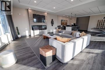 Hamilton condo for rent - A modern living room with a grey carpet and a white sofa.