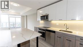 Hamilton condo for rent - A modern kitchen with a white countertop and stainless steel appliances.