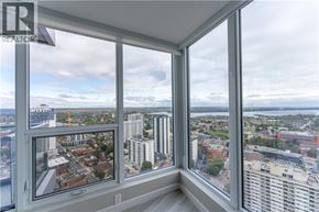 Hamilton condo for rent - A view from a high-rise window looking out at a cityscape.