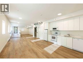 Squamish apartment for rent - A well-lit kitchen with white cabinets and a wooden floor.