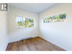 Squamish apartment for rent - A room with a window showing trees outside.