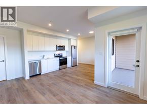 Squamish apartment for rent - A kitchen with white cabinets and a wooden floor.