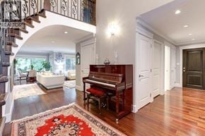 North Vancouver apartment for rent - A grand piano sits in a spacious room with a staircase on the left.