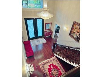 North Vancouver apartment for rent - A living room with a red rug and a chandelier.