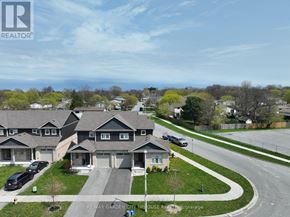 St. Catharines (Haig) apartment for rent - A house with a grey roof and a brown fence is shown in the image.