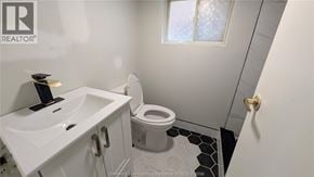 Windsor apartment for rent - A white sink and toilet in a small bathroom.