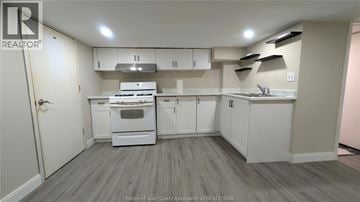 Windsor apartment for rent - A kitchen with white appliances and cabinets.