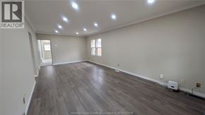 Windsor apartment for rent - A spacious room with wooden flooring and recessed lighting.