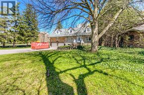 Waterloo apartment for rent - A shadow of a person is cast on the grass in front of a house.