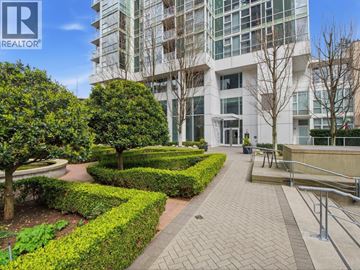Vancouver apartment for rent - A living room with a grey sofa and a view of the city.