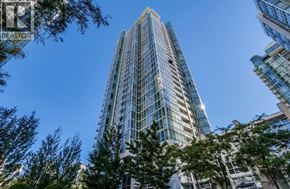 Vancouver apartment for rent - A tall glass building stands in front of other buildings and trees.