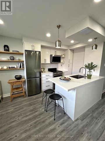 Toronto (Annex) multi-family for rent - A kitchen with a white counter and a black chair.