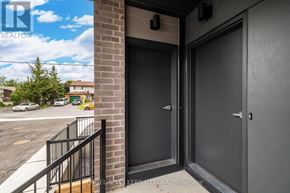 Ottawa apartment for rent - A realtor's sign is displayed on a building in the background of a photo showing a door entrance.