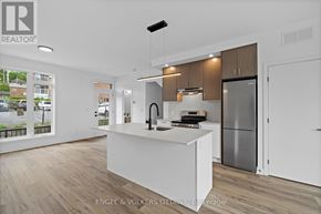 Ottawa apartment for rent - A modern kitchen with wooden floors and white countertops.