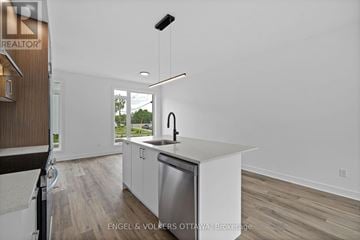 Ottawa apartment for rent - A modern kitchen with a dishwasher and a refrigerator.