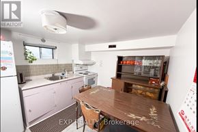 Toronto (Newtonbrook West) apartment for rent - A kitchen with pink cabinets and a wooden table.