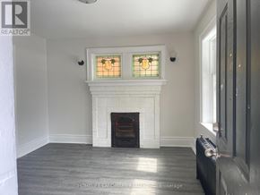 Hamilton (Crown Point) multi-family for rent - A white fireplace with a stained glass window above it.