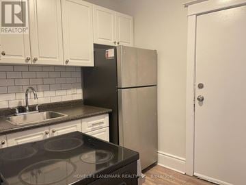 Hamilton (Crown Point) multi-family for rent - A kitchen with a black stove top and a white refrigerator.