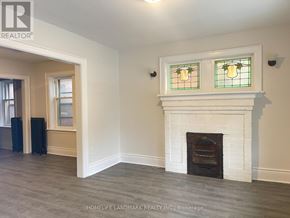 Hamilton (Crown Point) multi-family for rent - A room with a fireplace and two windows above it.