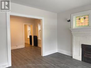 Hamilton (Crown Point) multi-family for rent - A room with a fireplace and a stained glass window.