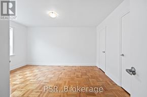 Toronto (Stonegate-Queensway) multi-family for rent - A room with a wooden floor and white walls.