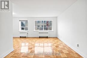 Toronto (Stonegate-Queensway) multi-family for rent - A room with a large window and a view of a building across the street.