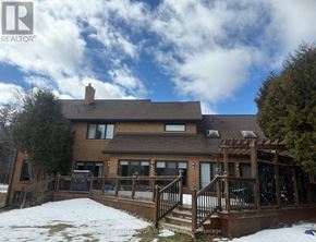 King (King City) apartment for rent - A house with a brown roof and a deck in the snow.