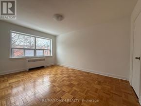 Toronto (Stonegate-Queensway) multi-family for rent - A room with a window and a radiator on the wall.