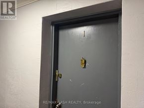 Toronto (Stonegate-Queensway) multi-family for rent - A door with a gold doorknob is in a white wall.