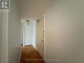 Toronto (Stonegate-Queensway) multi-family for rent - A hallway with a door at the end.