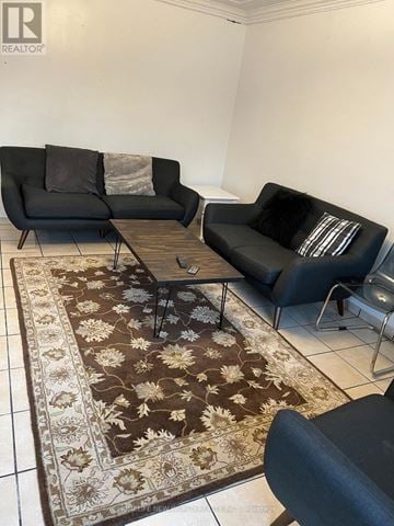 London East (East B) apartment for rent - A living room with a rug and two black couches.