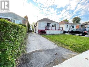 Toronto (Birchcliffe-Cliffside) apartment for rent - A residential street with houses and parked cars.