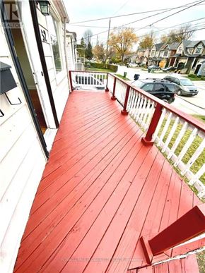 Toronto (Birchcliffe-Cliffside) apartment for rent - A red wooden deck with a white railing.