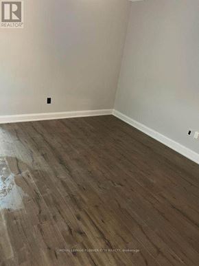 Toronto (Birchcliffe-Cliffside) apartment for rent - A room with wooden flooring and a white wall.