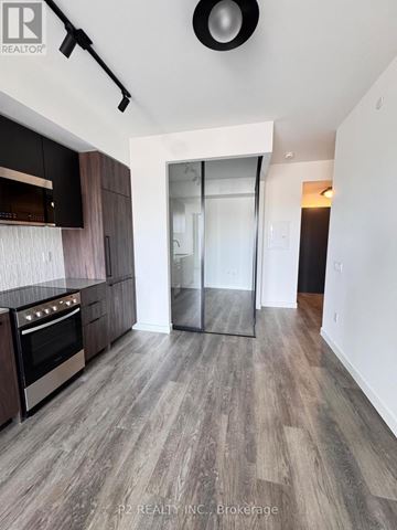 Toronto (Highland Creek) condo for rent - A modern kitchen with dark wood cabinets and a stainless steel oven.